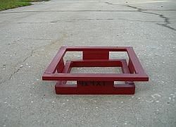 Riser for reclaim water box covers, a red steel square frame on short legs